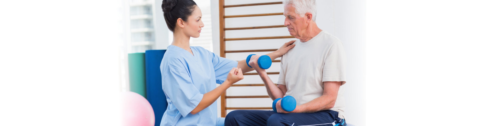 old man receiving physical therapy from young nurse